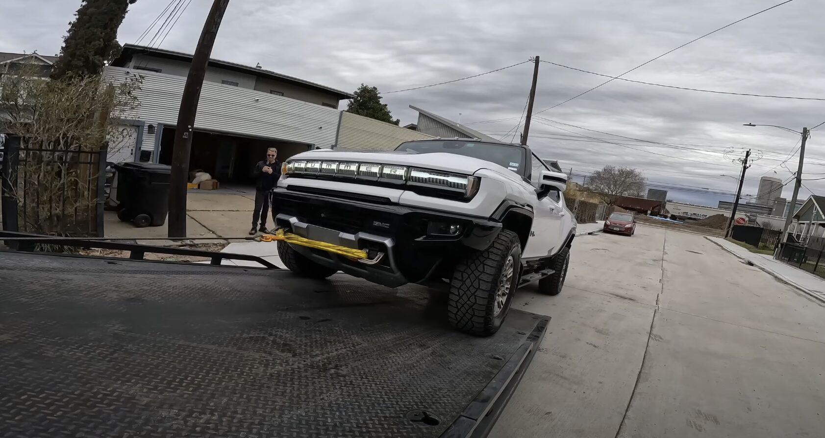 Flatbed tow truck loading a vehicle safely